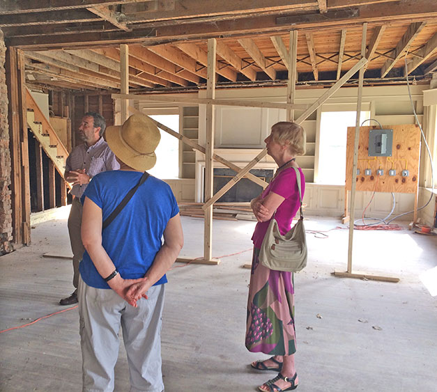 three people inside a house under construction